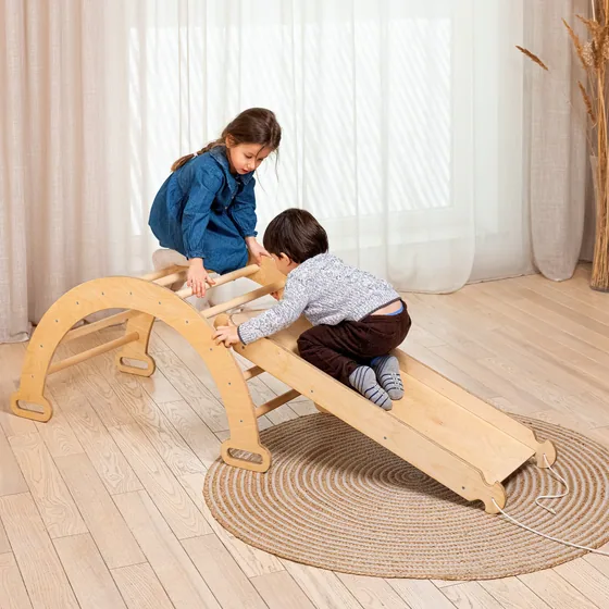 Children playing on wooden climbing playset