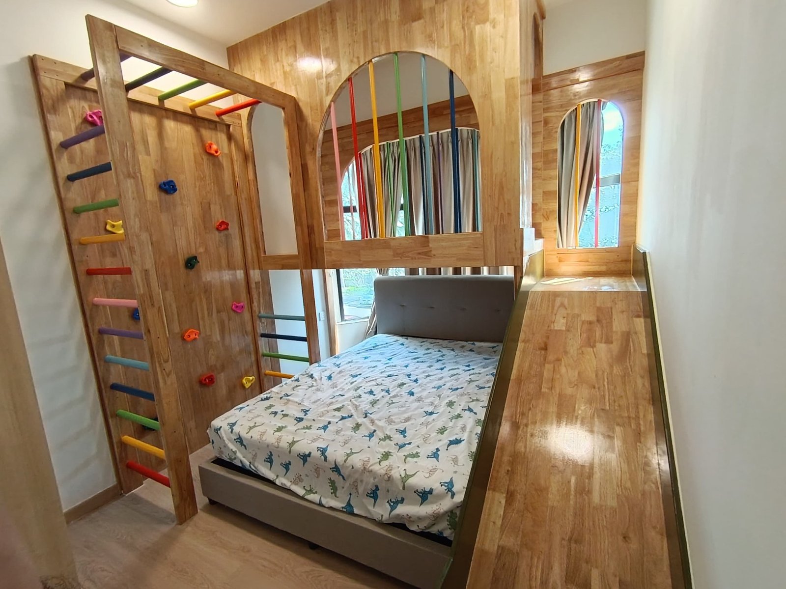 Custom Hijau Garden playbed with climbing wall, rainbow bars and slide